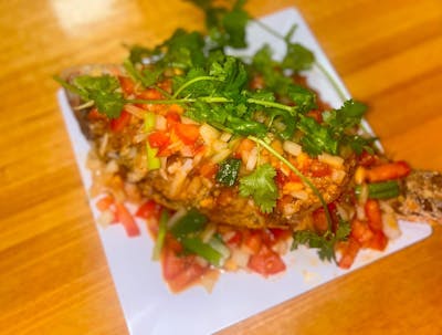 Whole fried Red Snapper with tomato sauce