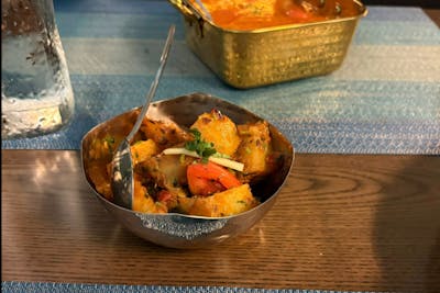 cumin‑spiced potatoes garnished with ginger and cilantro