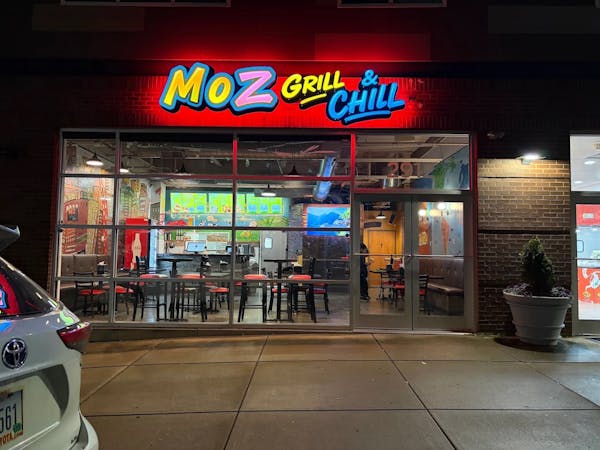 Moz Grill & Chill storefront at night