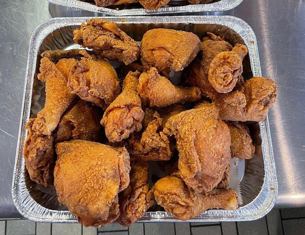 Tray of crispy fried chicken legs and thighs