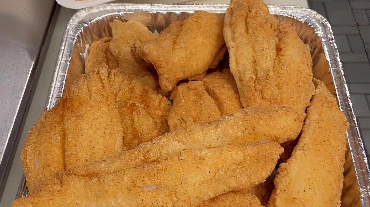 Tray of golden fried fish fillets
