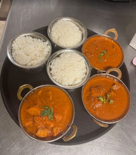 popular Indian dishes, such as Chicken Tikka Masala and Butter Chicken, served with sides of steamed white rice