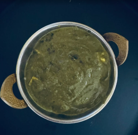 Saag Paneer, a popular North Indian dish consisting of a creamy, spiced puree of leafy greens (saag) and cubes of Indian cottage cheese (paneer)