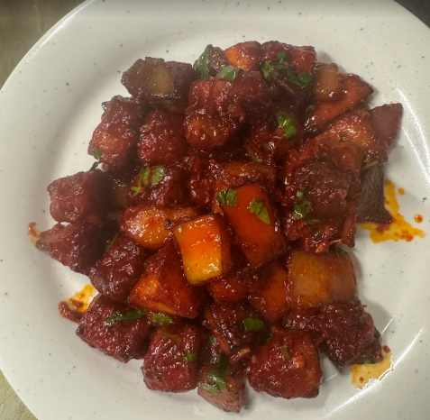 Chicken 65, a famous South Indian deep-fried chicken dish known for its vibrant red color and spicy flavor profile