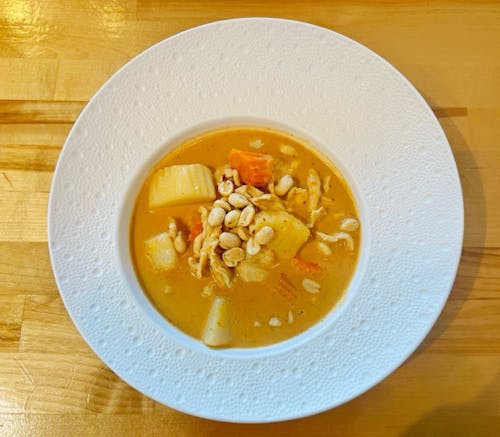 peanut‑topped curry with chicken, potatoes and carrots