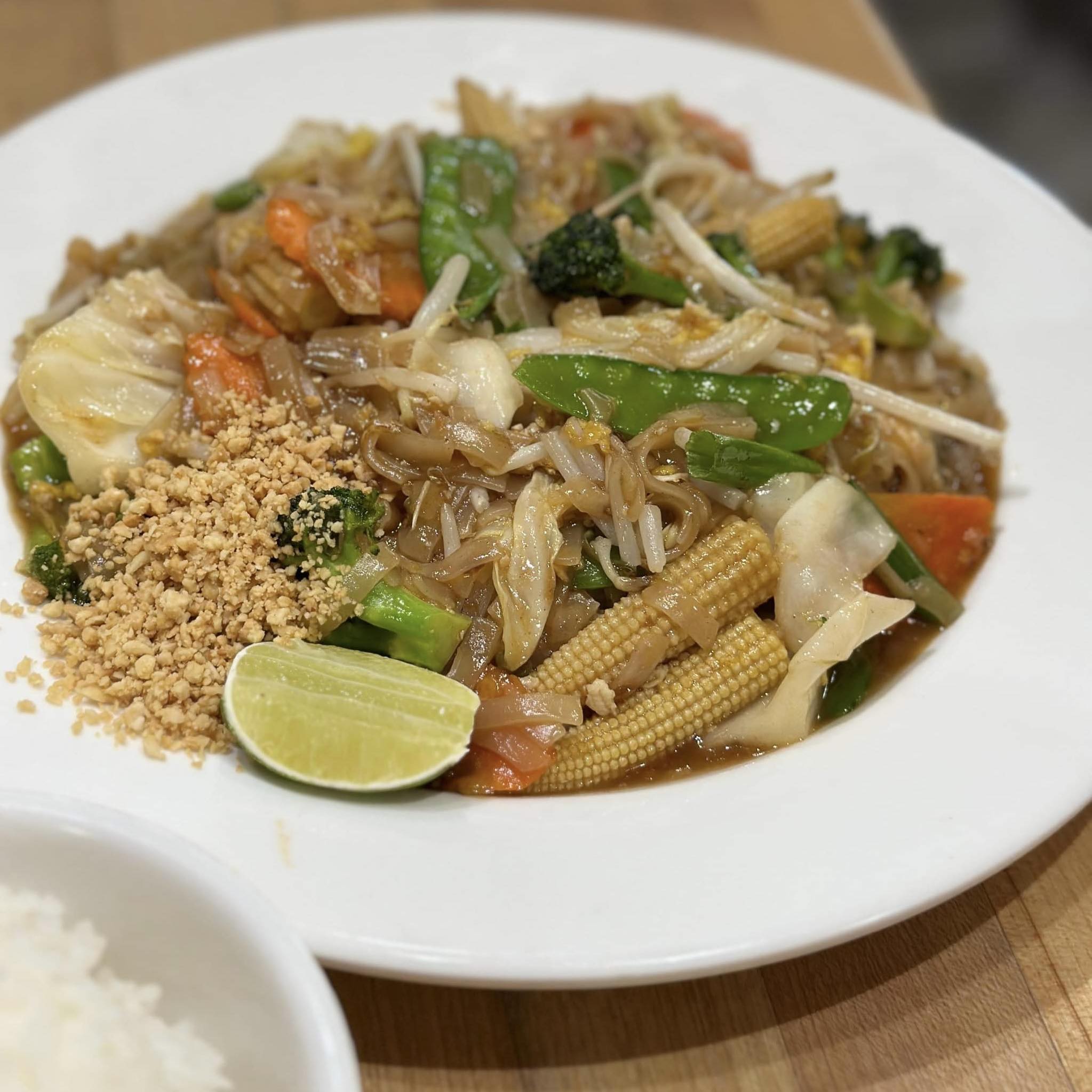 Stir‑fried rice noodles with vegetables, lime, and crushed peanuts at Chopsticks Noodle Cafe & Thai, Aurora IL