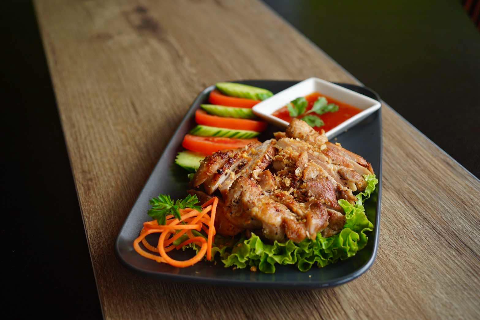 Thai grilled chicken with cucumber, tomato, and sweet chili sauce at Chopsticks Noodle Cafe & Thai, Aurora IL.