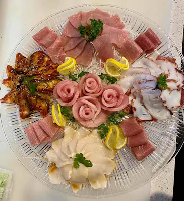 Assorted sashimi platter with tuna roses, octopus, eel, and white fish