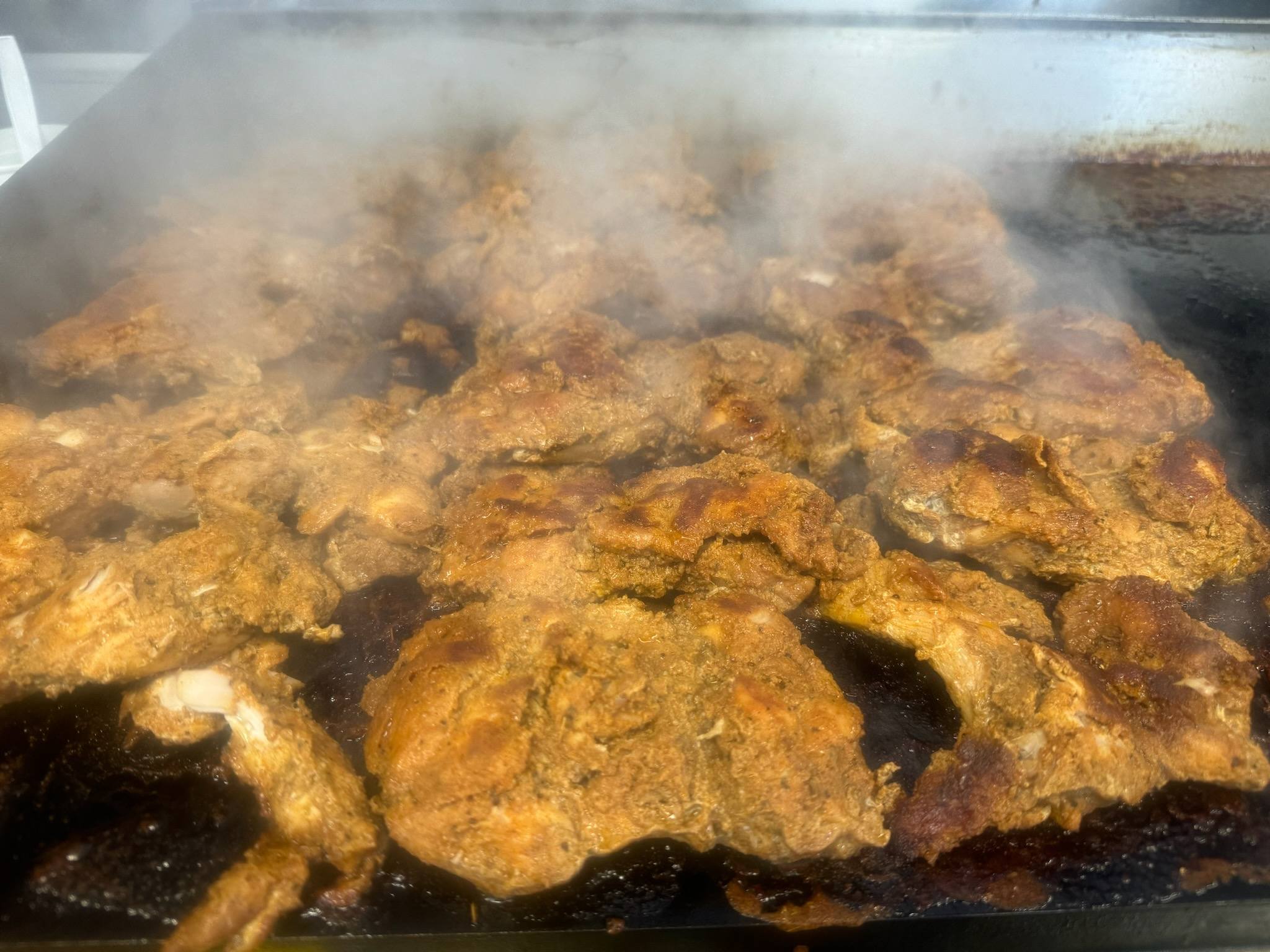 Sizzling meat on a griddle