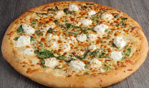 Large white pizza with spinach and ricotta dollops on a crisp crust