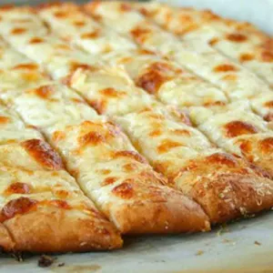 Cheesy breadsticks—baked pizza dough cut into strips with melted mozzarella