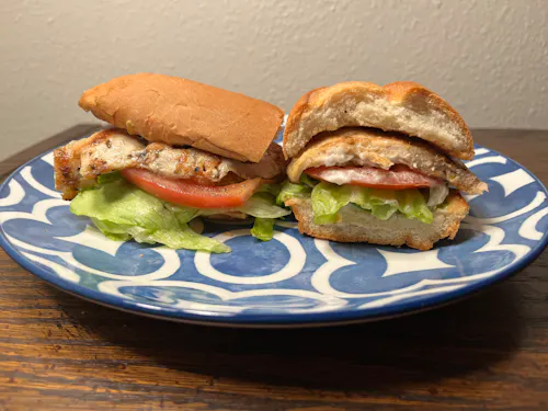 chicken sandwich with lettuce and tomatoes